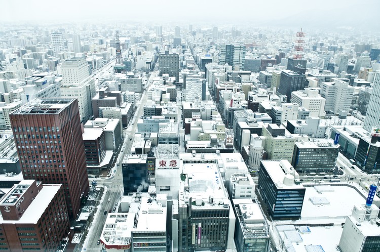Under the heavy blanket of snow, the concrete outlook of Sapporo is soften.