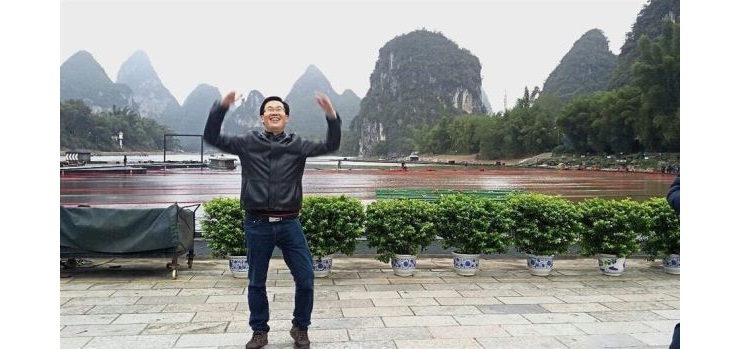 Daylight view: Senior project manager of Impression Melaka, Pang Bak Chua posing in front of the natural arena in Yangshuo, China during the day.